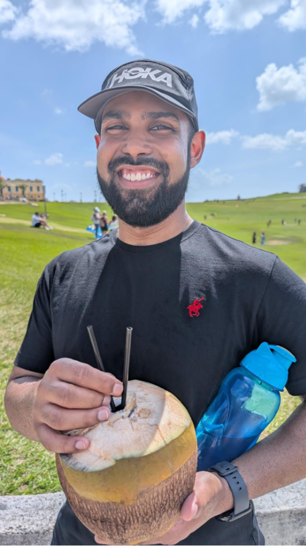 Mohammad Sadic holds a coconut with straws